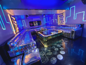 Phòng karaoke KTV 1127 Trần Hưng Đạo với ghế sofa và ánh sáng xanh.